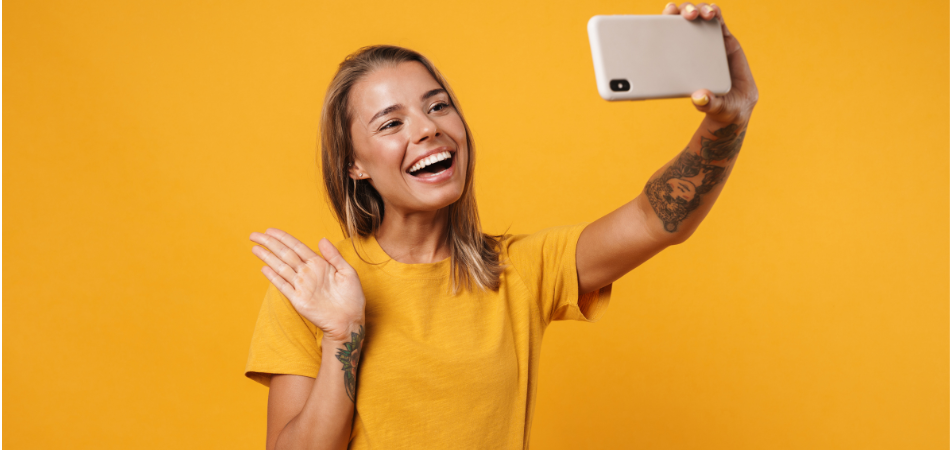 woman waving at her phone